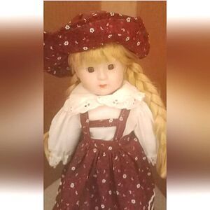 16" porcelain doll with blonde braided hair and bonnet